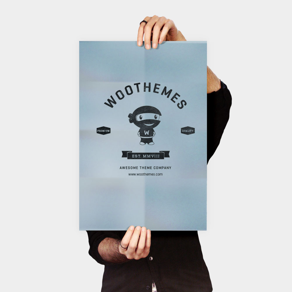 A person holding up a poster with the woothemes logo on it.